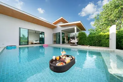 a villa with a swimming pool with a table with food on it at Garden pool villa V110 in Kata Beach