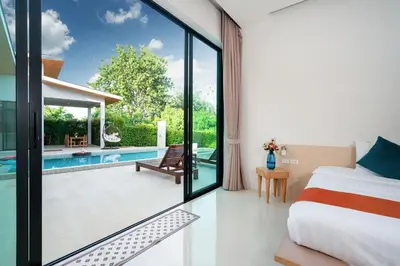 a bedroom with a bed and a swimming pool at Garden pool villa V110 in Kata Beach