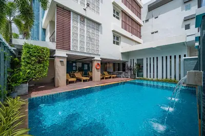 a swimming pool in front of a building at Ratana Hotel Rassada, PHUKET TOWN- SHA Extra Plus in Phuket Town