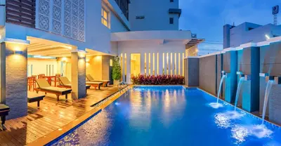 a swimming pool in the middle of a house at Ratana Hotel Rassada, PHUKET TOWN- SHA Extra Plus in Phuket Town