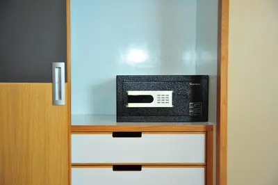 a microwave oven sitting on top of a cabinet at Ratana Hotel Rassada, PHUKET TOWN- SHA Extra Plus in Phuket Town