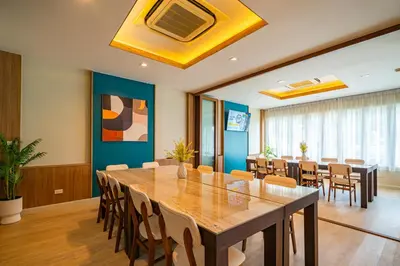 a conference room with a large wooden table and chairs at Ratana Hotel Rassada, PHUKET TOWN- SHA Extra Plus in Phuket Town