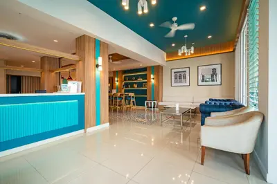 a lobby with a bar and a dining room at Ratana Hotel Rassada, PHUKET TOWN- SHA Extra Plus in Phuket Town