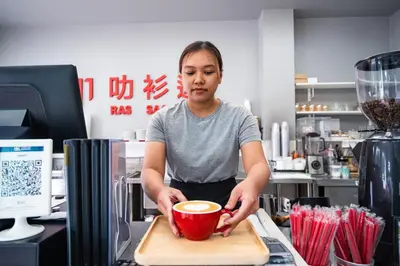 a woman holding a red bowl on a cutting board at Ratana Hotel Rassada, PHUKET TOWN- SHA Extra Plus in Phuket Town
