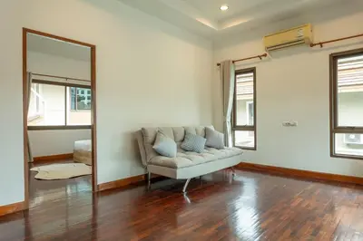 a living room with a couch and a mirror at Center Stay from Patong Bangla Walking Street V107 in Patong Beach