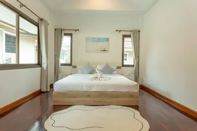 a bedroom with a large white bed with a large window at Center Stay from Patong Bangla Walking Street V107 in Patong Beach