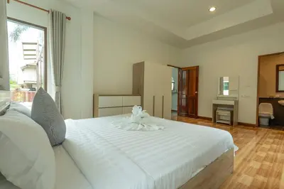 a large white bed in a room with a desk at Center Stay from Patong Bangla Walking Street V107 in Patong Beach