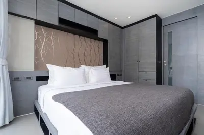 a bedroom with a large bed with white pillows at Tropics Pool View 2BR Kamala Apartment CTG P605-6, near Beach in Kamala Beach