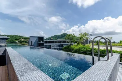 an infinity pool on the roof of a building at Tropics Pool View 2BR Kamala Apartment CTG P605-6, near Beach in Kamala Beach