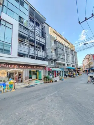 an empty street in front of a large building at Patong Max Value Hotel in Patong Beach