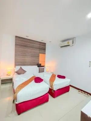 two beds in a hotel room with at Patong Max Value Hotel in Patong Beach