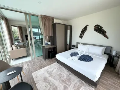 a bedroom with a bed with white sheets and pillows at Apartment with panoramic views at Oceana by Lofty in Kamala Beach