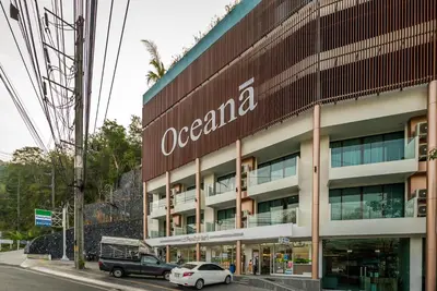a building with a sign on the side of it at Apartment with panoramic views at Oceana by Lofty in Kamala Beach