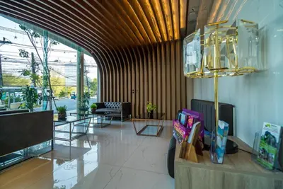 a lobby with a couch and a chandelier at Apartment with panoramic views at Oceana by Lofty in Kamala Beach