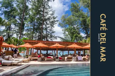 a swimming pool with chairs and umbrellas next to a resort at Luxury Apartment at a Bargain in Kamala Beach