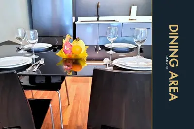 a dining room table with glasses and plates on it at Luxury Apartment at a Bargain in Kamala Beach