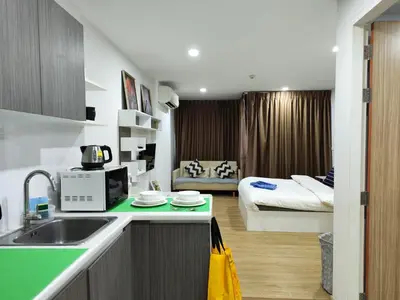 a kitchen with a sink and a room with a bed at 7 Floor - Mountain view Studio room at OZC near Kata beach in Kata Beach
