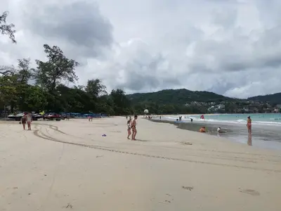 a group of people standing on a beach at 7 Floor - Mountain view Studio room at OZC near Kata beach in Kata Beach