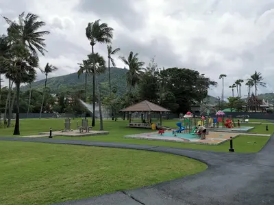 a park with a playground and a gazebo and palm trees at 7 Floor - Mountain view Studio room at OZC near Kata beach in Kata Beach