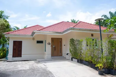 a house with a red roof at Coco Golf Villa in Ban Huai Luk (1)
