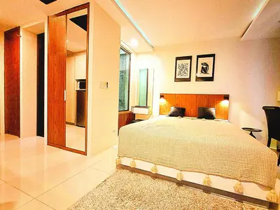 a bedroom with a large bed and a large window at Studio Apartment 400m from Rawai Beach in Phuket Town