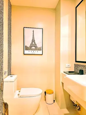 a bathroom with a toilet and a picture of the eiffel tower at Studio Apartment 400m from Rawai Beach in Phuket Town