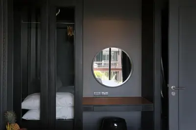 a round mirror in a room with a bedroom at Saturdays by Holy Cow, pool view in Rawai Beach