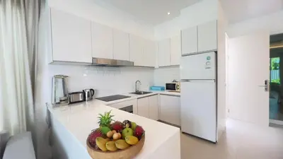 a kitchen with a bowl of fruit on a counter at Kamala Garden View Baan Ratri 4 in Kamala Beach