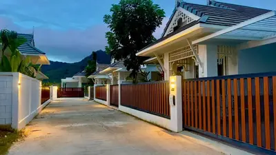a row of houses with a fence and a driveway at Kamala Garden View Baan Ratri 4 in Kamala Beach
