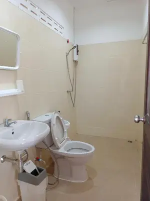 a bathroom with a white toilet and a sink at B&N House in Nai Yang Beach