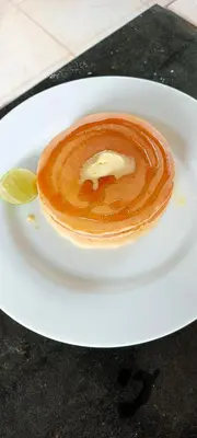 a white plate with a dessert on a table at B&N House in Nai Yang Beach