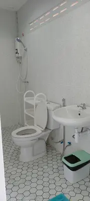 a bathroom with a toilet and a sink at B&N House in Nai Yang Beach