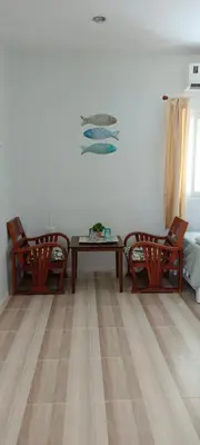 a living room with two chairs and a table at B&N House in Nai Yang Beach