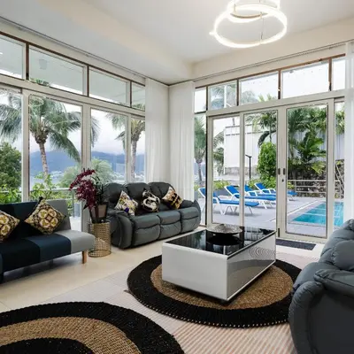 a living room with a couch and a table at Vipa Seaview Villa in Patong Beach