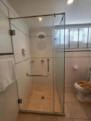 a glass shower in a bathroom with a toilet at Vipa Seaview Villa in Patong Beach
