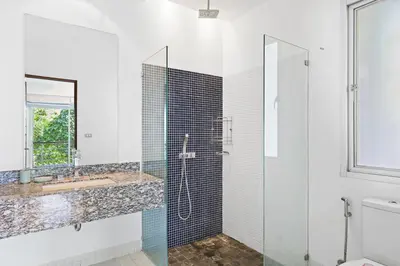 a bathroom with a glass shower and a sink at Kamala Hills Naka - Villa 15 in Kamala Beach