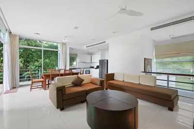 a living room with two couches and a table at Kamala Hills Naka - Villa 15 in Kamala Beach