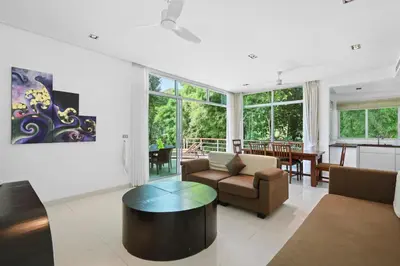 a living room with a couch and a table at Kamala Hills Naka - Villa 15 in Kamala Beach