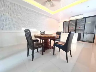 a dining room with a wooden table and chairs at บ้านพัก น้ำตกกะทู้ in Ban Huai Luk (1)