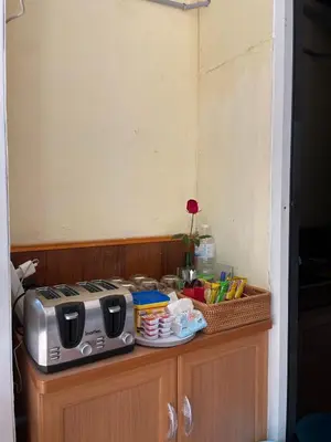 a kitchen counter with a toaster and a basket on it at Easy Hostel in Phi Phi Don