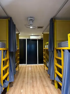 a room with three bunk beds and a hallway at Easy Hostel in Phi Phi Don