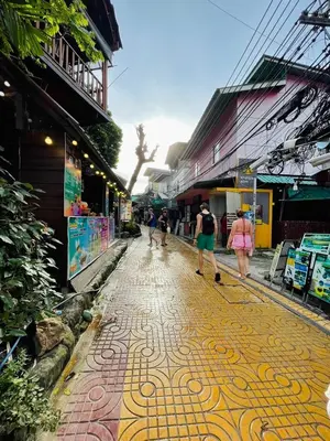 a group of people walking down a street at Easy Hostel in Phi Phi Don