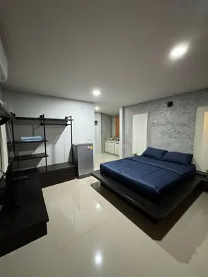 a bedroom with a blue bed and a television at Mimi Home in Ko Yao Noi