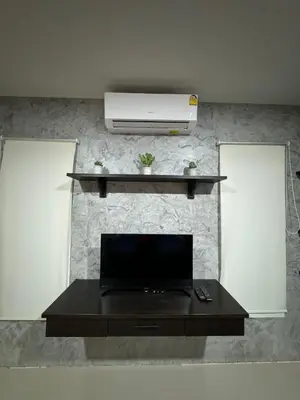 a living room with a tv on a wall at Mimi Home in Ko Yao Noi