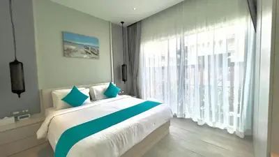 a bedroom with a bed and a large window at Kamala Garden View Villas by Aladdin in Kathu