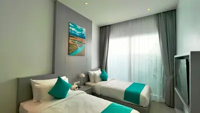 a hotel room with two beds and a window at Kamala Garden View Villas by Aladdin in Kathu