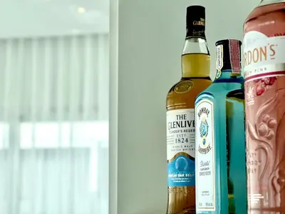 two bottles of alcohol sitting on a shelf at Kamala Garden View Villas by Aladdin in Kathu