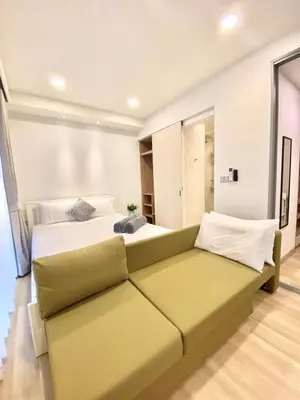 a large bed with a couch in a room at Cozy 1BR in Laguna Skypark Celeste Bangtao, Iinfinity Pool in Bang Tao Beach