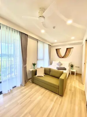 a living room with a couch and a bed at Cozy 1BR in Laguna Skypark Celeste Bangtao, Iinfinity Pool in Bang Tao Beach
