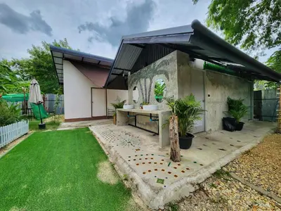 a garden with a concrete building with a sink at Bambus Restaurant, Bar & Hostel in Patong Beach